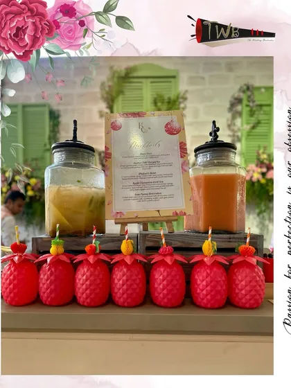 Fun pineapple-shaped glasses filled with a refreshing drink for the Haldi party.