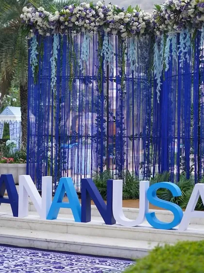 A personalized touch with the couple's names in large letters, painted in shades of blue and white to match the event's color scheme.