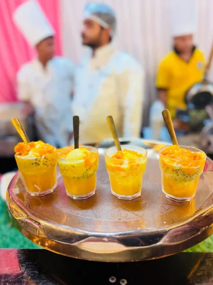A tray of freshly prepared Mango Falooda, layered with mango pulp, vermicelli, and ice cream.