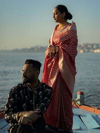 A stunning portrait of a couple on a boat in Varanasi. The serene water and the golden hour light create a breathtaking backdrop for this pre-wedding shoot.