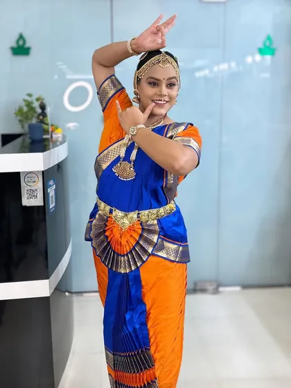 One of the dancers posing in her full costume. The makeup is designed to be visible and expressive from a distance.