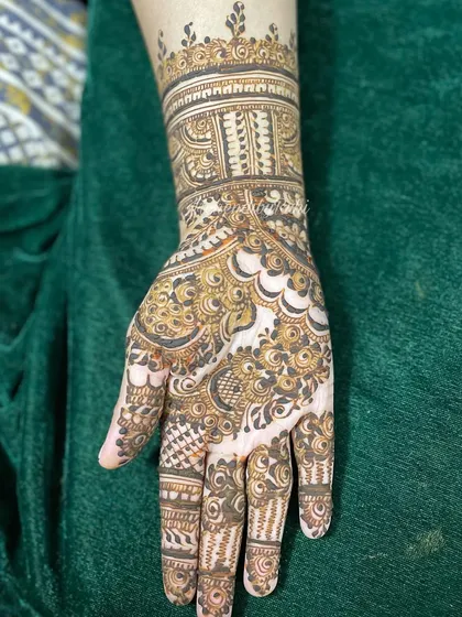 A single-hand close-up of a full bridal design. This view highlights the intricate cuff work on the wrist and the detailed patterns on the palm and fingers.