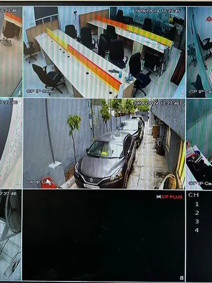 A live multi-camera view from a recent office installation in Gurgaon. This system uses CP Plus IP cameras to provide comprehensive coverage of workstations, entry points, the parking area, and private cabins, all visible on a single screen.