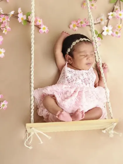 Pretty in pink. This little girl is having sweet dreams on her floral swing. It's such a lovely and feminine setup.