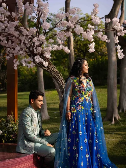 A beautiful portrait of the couple under the cherry blossom tree at the 'Whispers of the Orient' carnival.