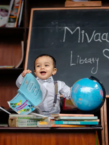 A creative 'Little Scholar' themed milestone shoot. I love bringing imaginative ideas to life, using props like books and a globe to create a fun and memorable scene for your child.