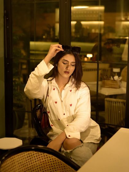 Adjusting my sunglasses, a classic cafe pose.