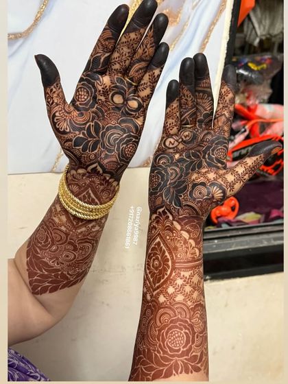 A full view of the contrasting hands, one with paste and one with the stain.