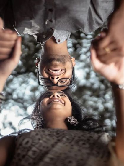 A fun, creative shot taken from a low angle, looking up at the couple. We love finding unique perspectives for our pre-wedding photography.