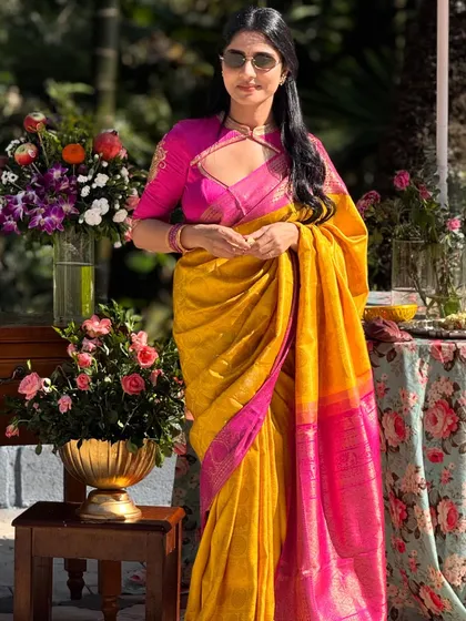 Traditional wear can be effortlessly chic. This look pairs a vibrant yellow Kanchivaram with a modern pink blouse featuring a distinctive keyhole neckline, showing how I blend classic weaves with contemporary design.
