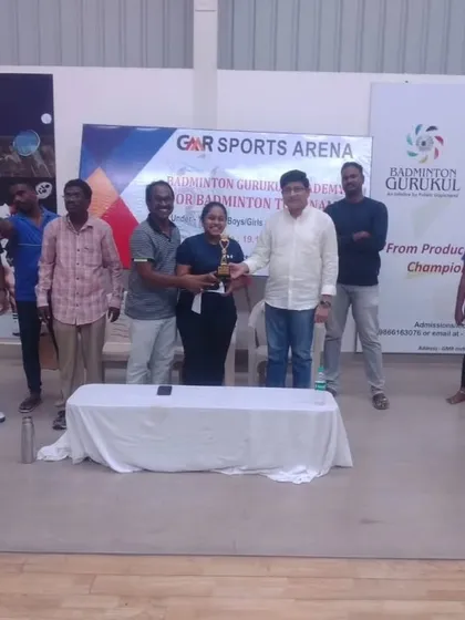 An adult winner receives her trophy, showing that our community events cater to all age groups.