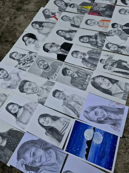 Another view of my recent creations laid out together. You can see the range of portraits, from individual headshots to more creative pieces.