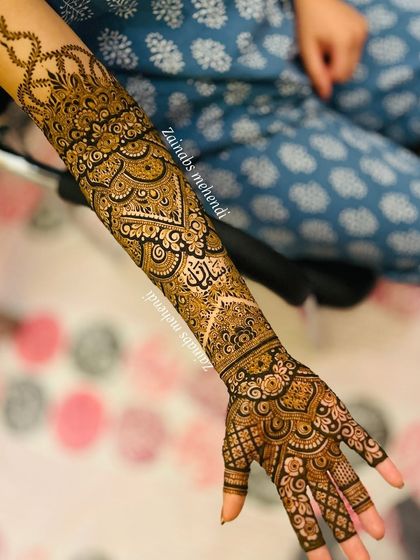 A full view of Afrah's bridal arm, with her name beautifully integrated into the design.