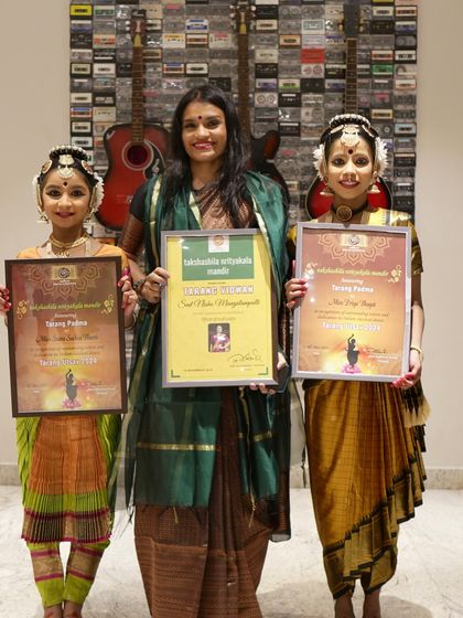 A proud moment with my students Priya and Saara after their excellent performances at Tarangutsava. I was also honored to receive the "Tarang Vidvan" award.