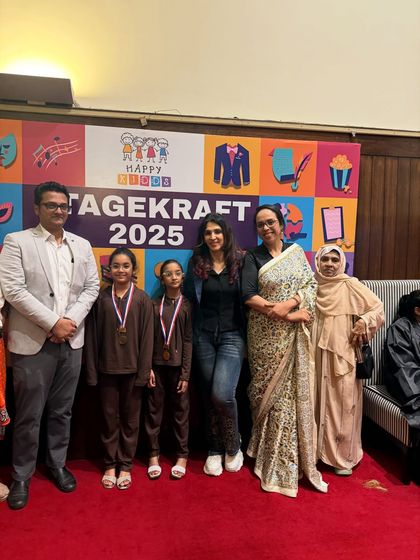 A group photo with our students and their proud families after the show. It's a community celebration.