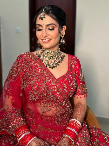 Another angle of this regal bridal look, showing the bride's joyful expression. The makeup is designed to be both beautiful and long-lasting.
