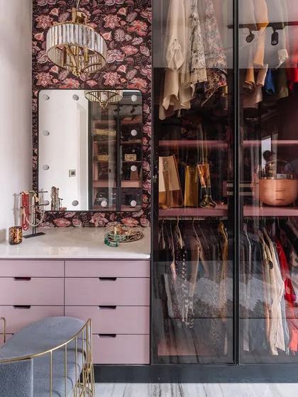 A full view of the 'Modern Muse' walk-in closet, showcasing the seamless integration of the vanity, drawers, and hanging space.