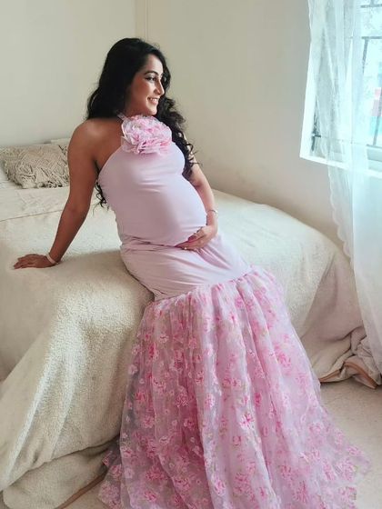Our client looking radiant in our Cherry Blossom gown. This pink mermaid-style dress features a beautiful floral-printed tulle trail.