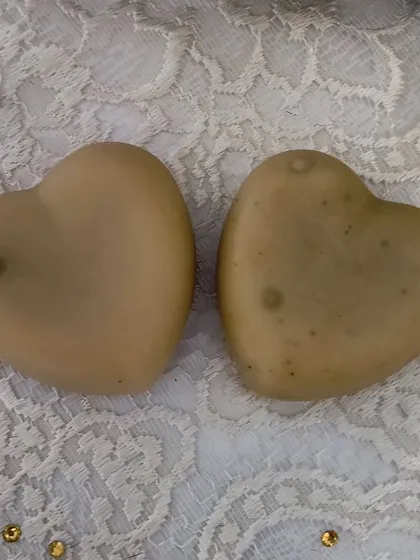 Two 'Hope' heart soaps. The natural botanicals create subtle speckles within the bar.