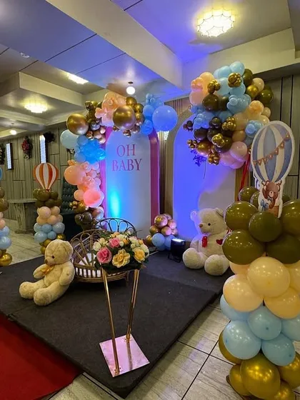 Another angle of the 'Oh Baby' banquet hall decoration, showing the stage, floral stands, and overall event space.