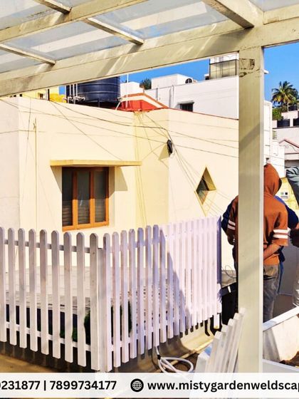 Our team installing the white picket fence on a terrace, ensuring it is securely fastened and perfectly aligned.