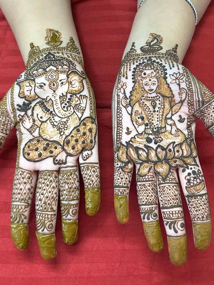 The full Diwali design, with the Ganesha and Lakshmi portraits framed by intricate patterns on the fingers and wrists.