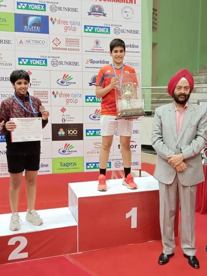 **Top of the Podium.** Anmol Kharb receiving her gold medal for the U-19 Girls' Singles event, solidifying her position as a top junior player in the country.