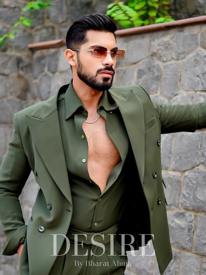 This image captures the versatility of the olive green suit. It can be worn buttoned up for a formal look or open for a more relaxed, confident vibe.
