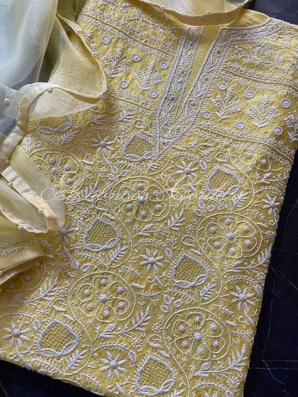 A close-up of the yoke, showing the intricate jaal, floral motifs, and sequin highlights.