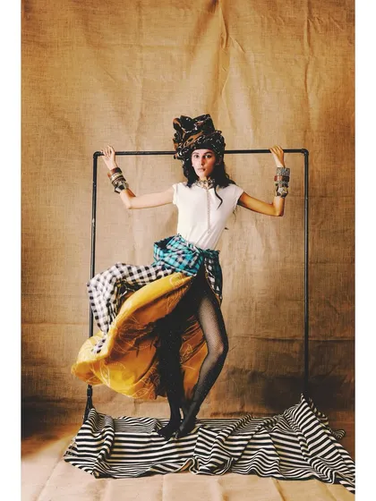 A dynamic shot from the 'Neo-Boheme' editorial. The styling is all about playful layering of different patterns and textures, creating a look that is eclectic and full of movement.