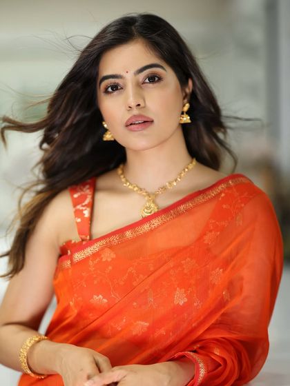 A confident and striking portrait of Amritha Aiyer, her makeup looking fresh and modern.