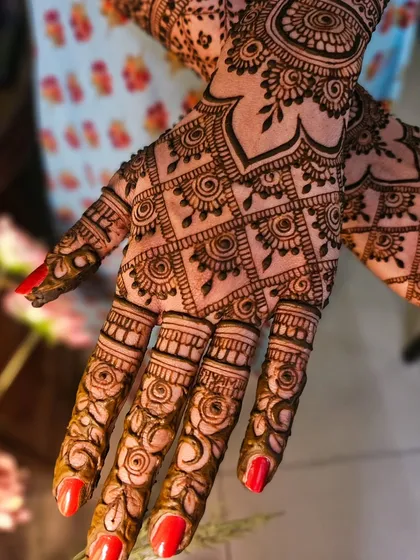 A close-up on the fingers, showing delicate rose patterns that add a romantic touch to the design.