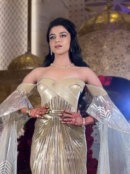 The bride is ready to own the night with her stunning gown and perfectly styled waves, a look that is both modern and timeless.