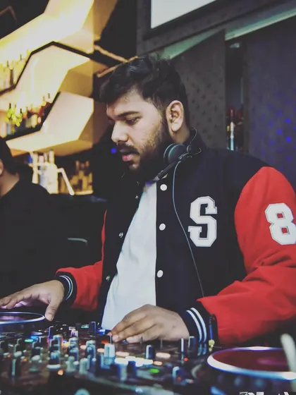 Working the turntables during a busy night. The grind is real but the reward of a full dance floor is worth it.