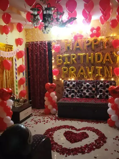 A closer view of the romantic birthday setup with the rose petal heart on the floor.