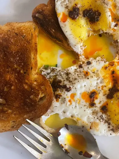 A breakfast of sunny-side-up eggs with toast. A simple, classic, and protein-packed way to start the day.