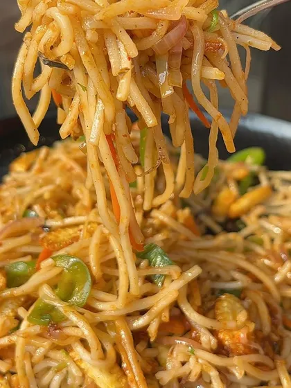 A forkful of my classic Hakka noodles, tossed with colourful bell peppers and other fresh vegetables. It's a light yet satisfying dish.