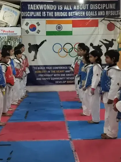Our youngest students lined up in their sparring gear, ready for practice. We make training safe and fun for all ages.