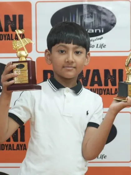 Double the joy, double the pride. We celebrate every achievement, big or small. Here, one of our young vocal students proudly displays his trophies after a successful performance at our annual function.