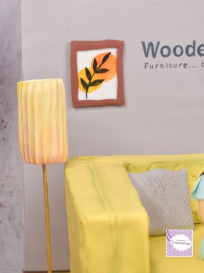 A detail shot of the hand-painted art and lamp beside the sofa.