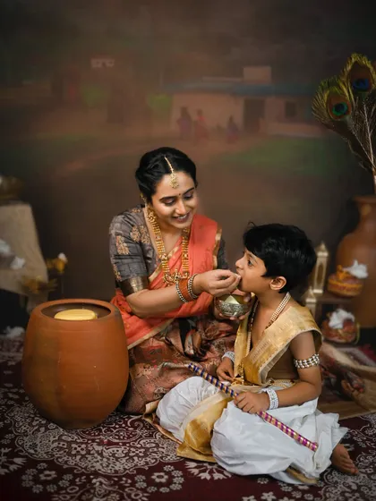 Another sweet moment of a mother feeding her son during their traditional photoshoot. These are memories they will both cherish.