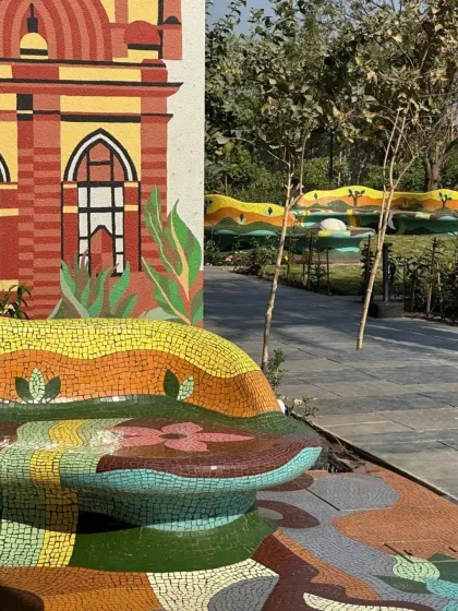 Another angle of the Rajkot project, highlighting the custom-built mosaic seating that is both a functional bench and a piece of sculpture, seamlessly integrated with the surrounding art.