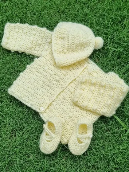 This is a baby bobble set I designed and made to order. It includes a sweater, hat, and booties, all with a fun, bubbly texture.