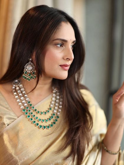 Another shot of the graceful Divya Spandana, showcasing her elegant side profile and the sophisticated makeup look.