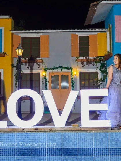 Our large "LOVE" sign prop makes a bold and beautiful statement, set against our colorful boathouse backdrops for a vibrant night shoot.