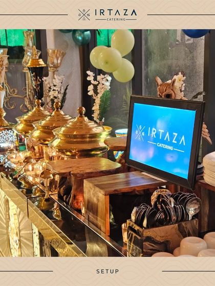Our branded display screen integrated into the buffet setup, surrounded by festive balloons and our signature golden serveware.