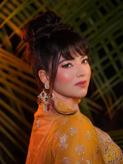 A profile shot that highlights the elegant updo and the beautiful contour of the face.