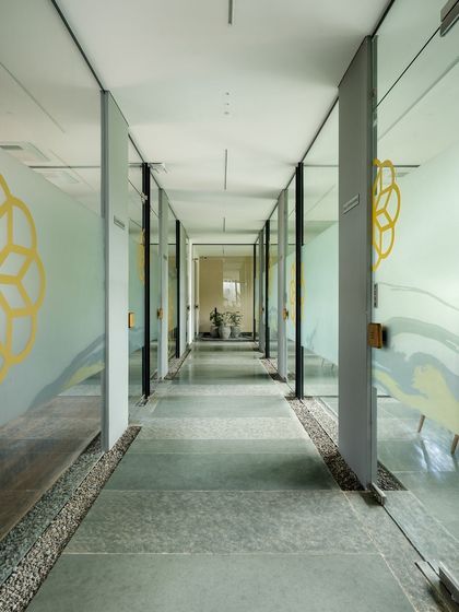 A corridor connecting the discussion rooms at the Soul Spring Experience Centre. Glass walls maintain visual openness, while frosted patterns provide privacy and carry the brand's design motif through the space.