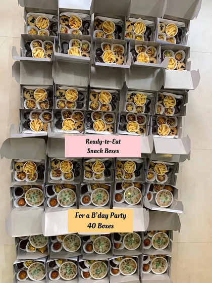 40 ready-to-eat snack boxes prepared for a birthday party.