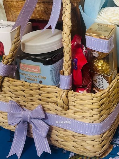 A close-up of the romantic birthday hamper, showing the Theobroma cookies and Ferrero Rocher chocolates nestled in the jute basket.